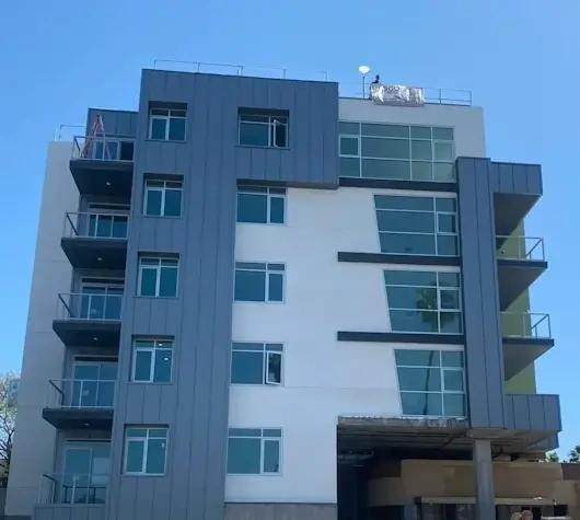 A small building with a tall brown metal roof.