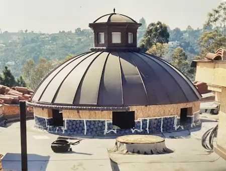 A circular metal roof on top of a building.