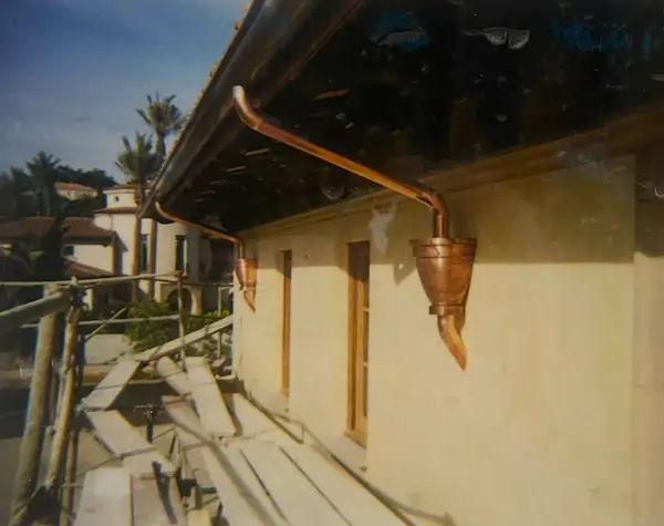A copper guttering system on a two floor apartment building.