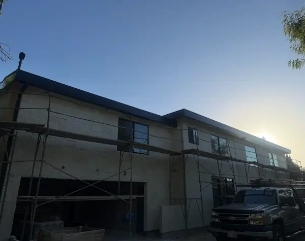 A flat gray metal roof on top of a residential home.
