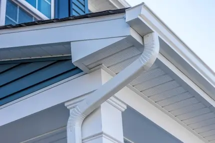 A matching white rain gutter on the side of a house.