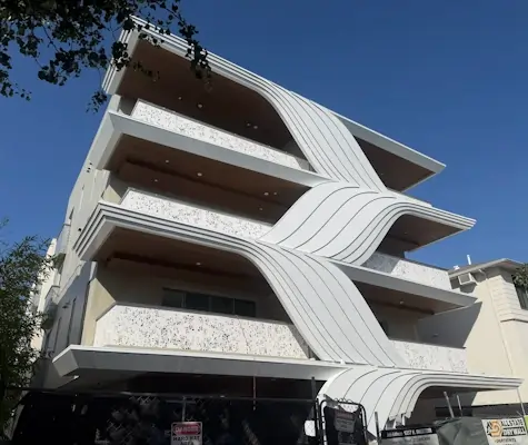 A white modern styled apartment building.
