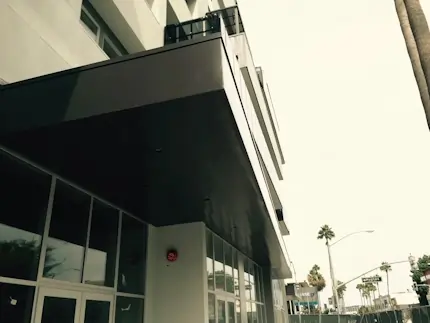 A metal entrance shade canopy at the enterance of a building.
