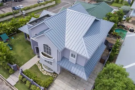 A metal seam roof on a suburban house.